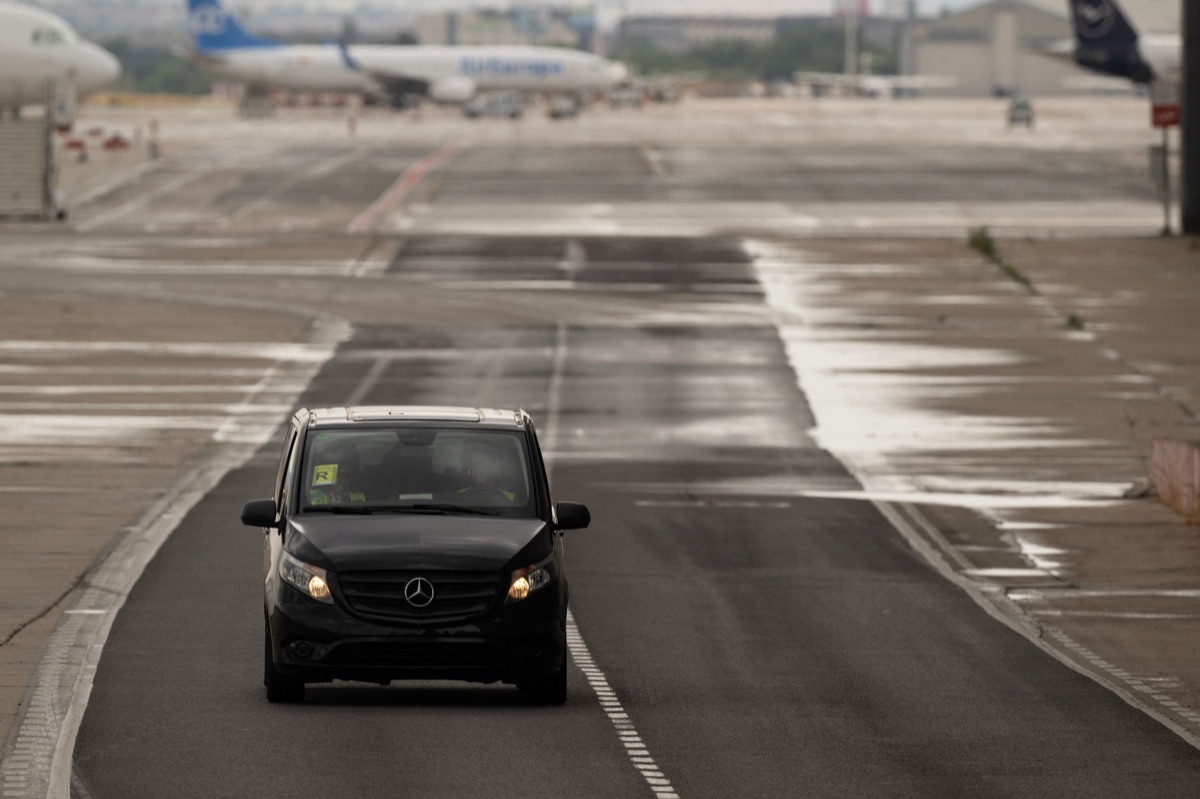 Rental car at airport with luggage