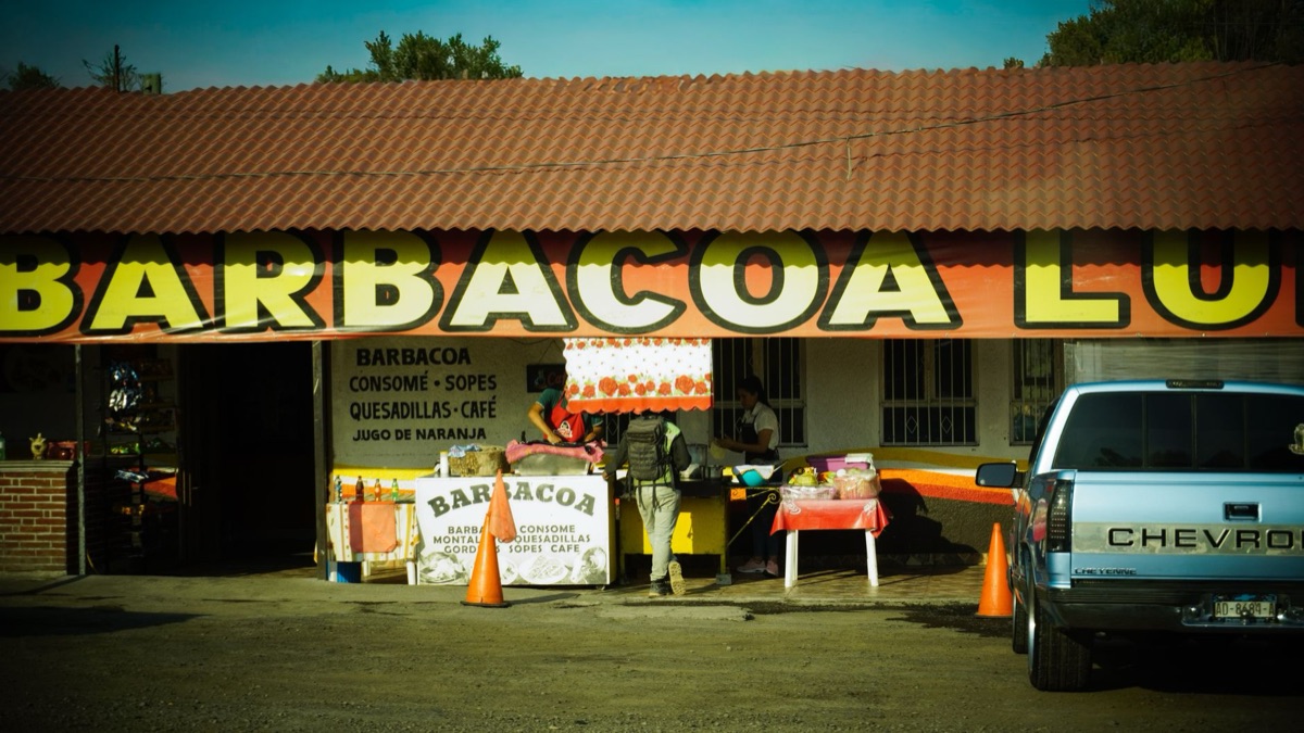 local person standing in front of taco truck
