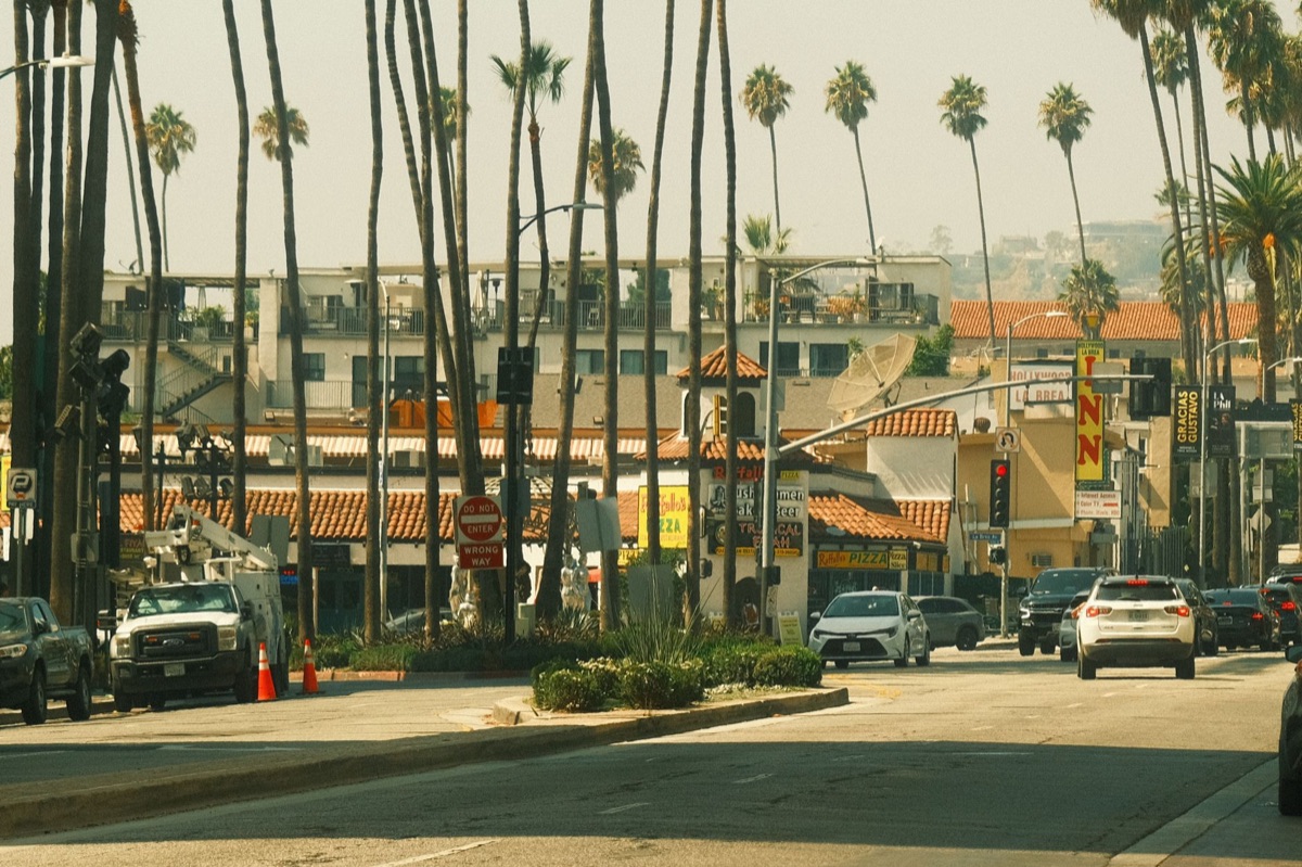 Los Angeles neighborhood with street signs and pedestrians