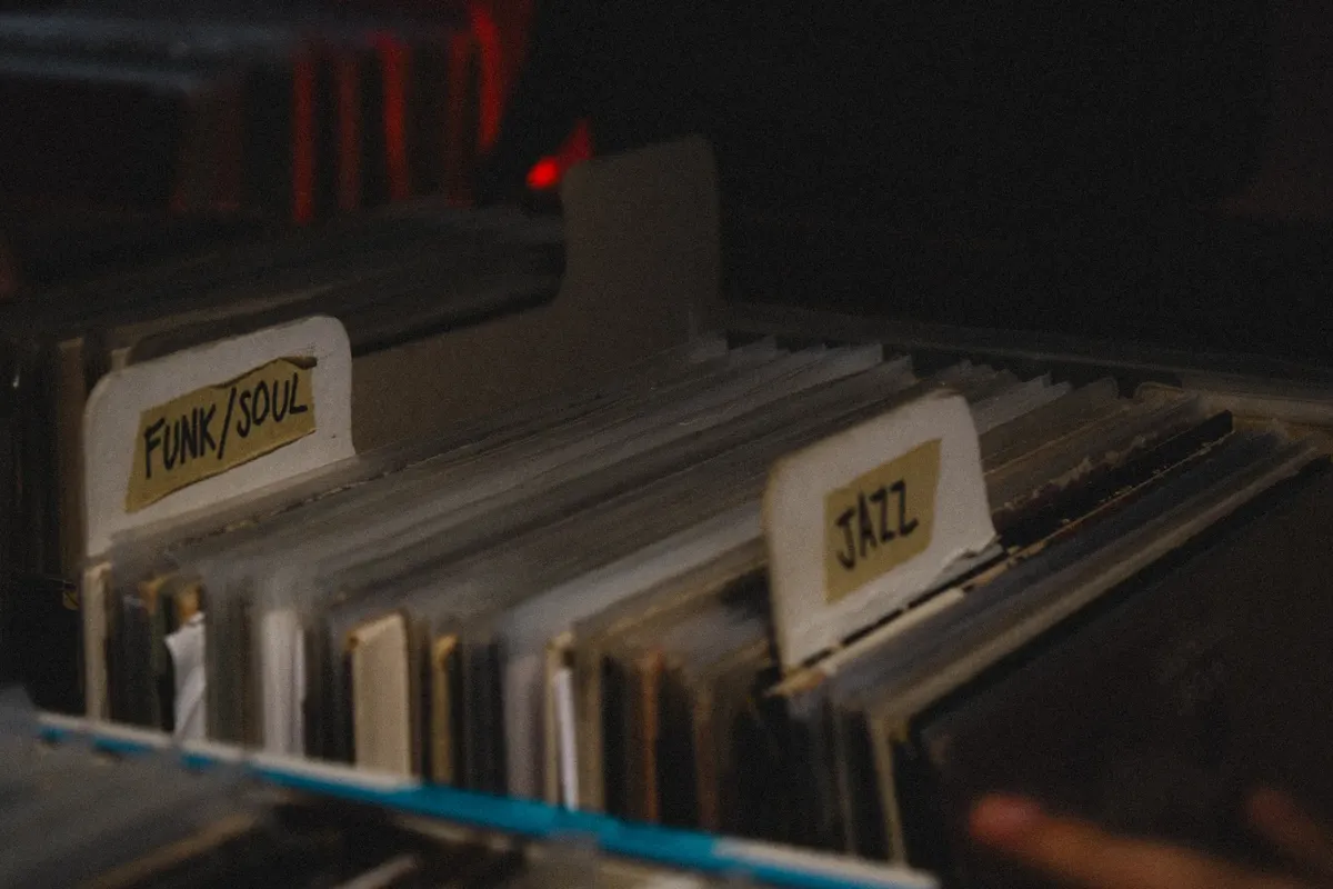 Collection of funk, soul, and jazz vinyl records sorted in a dimly lit environment.